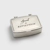 Silver matchbox with 'Spark a Revolution' text on a white background